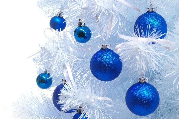 Snow-white Christmas tree with blue toys