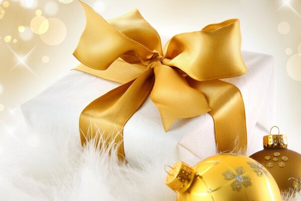 Golden Christmas balls with a golden ribbon