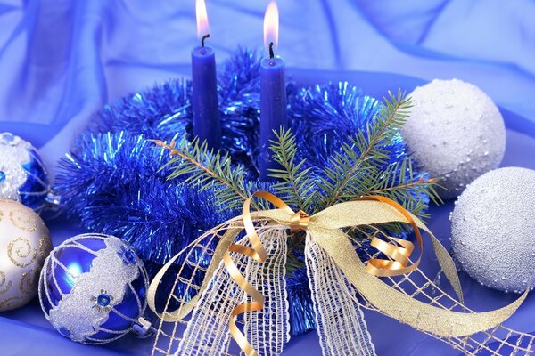 Two blue candles and Christmas decorations