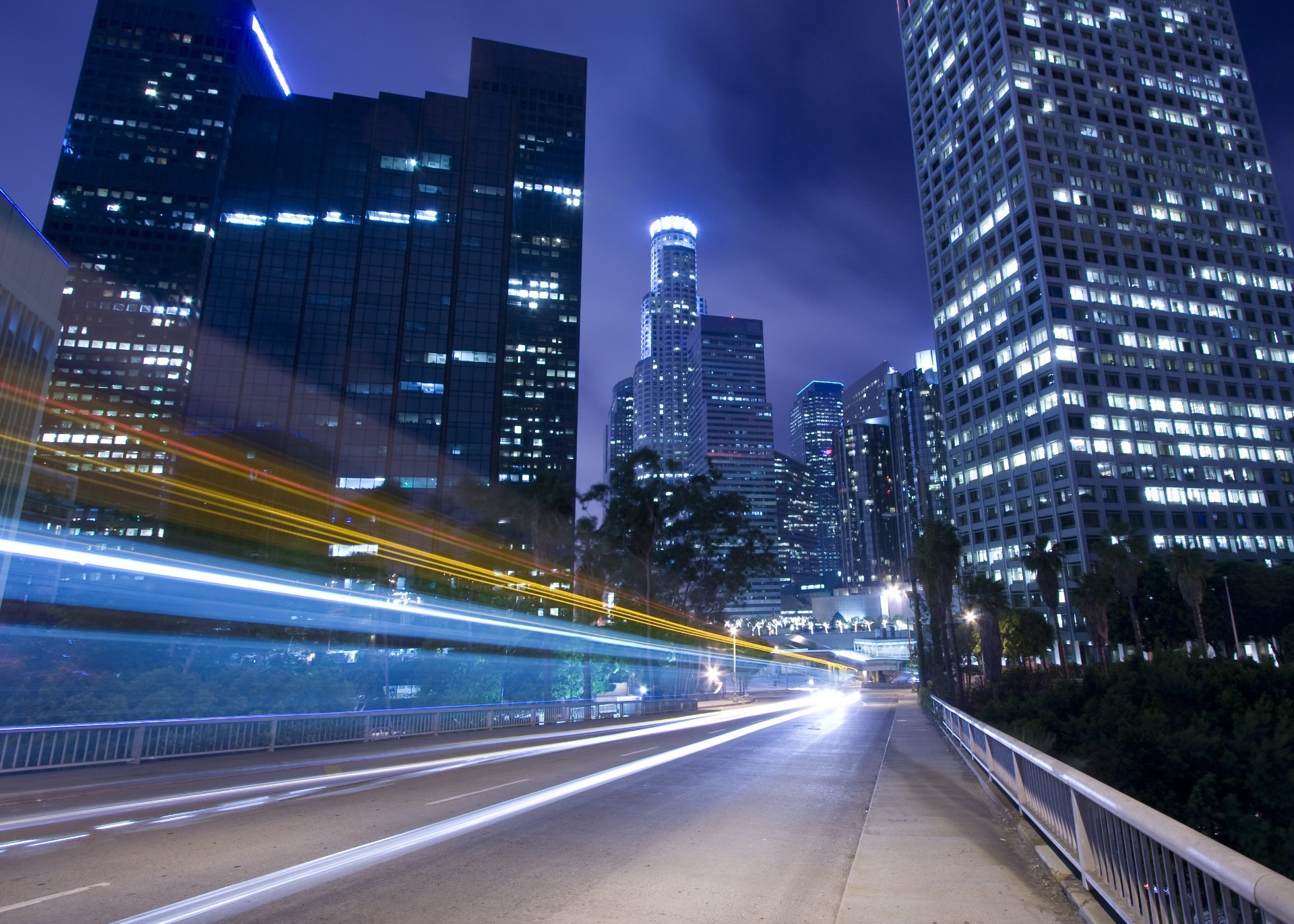 city downtown skyscraper dusk traffic road highway blur fast bus architecture evening transportation system urban cityscape building business bridge car motion