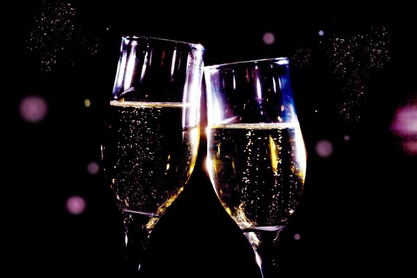 Two glasses of champagne on a blue background