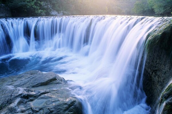 A stormy waterfall among the stones