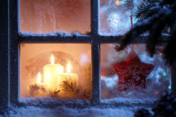 Christmas decorations in a snow-covered window