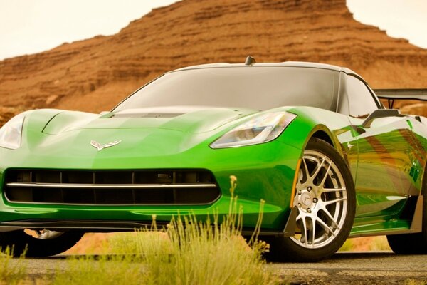 A sporty green car in the desert