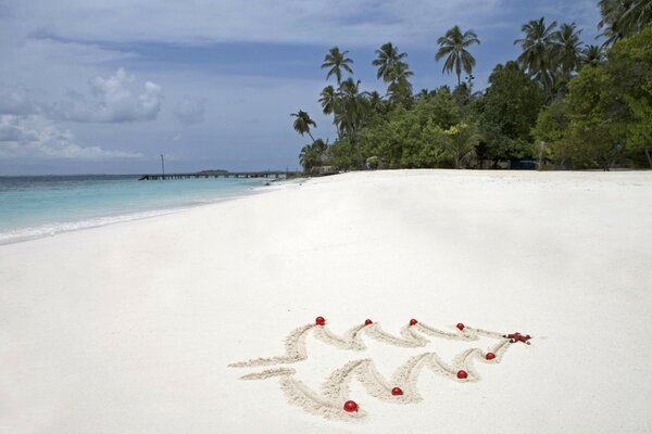 A Christmas tree is painted on the beach