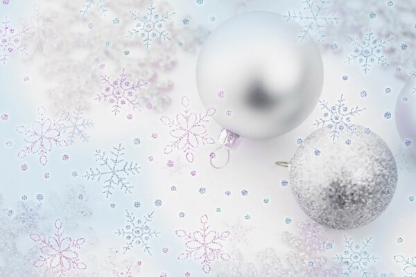 Silver balls on a background of snowflakes