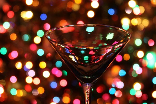 A glass on a background of multicolored lights