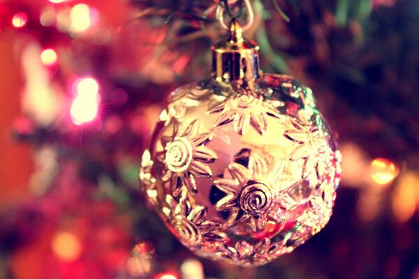 Carved red Christmas ball on the Christmas tree