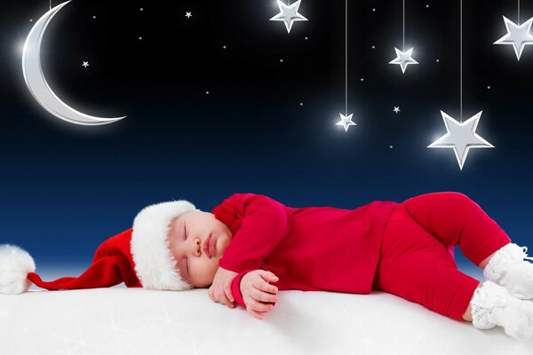 Bambino addormentato in costume da Babbo Natale