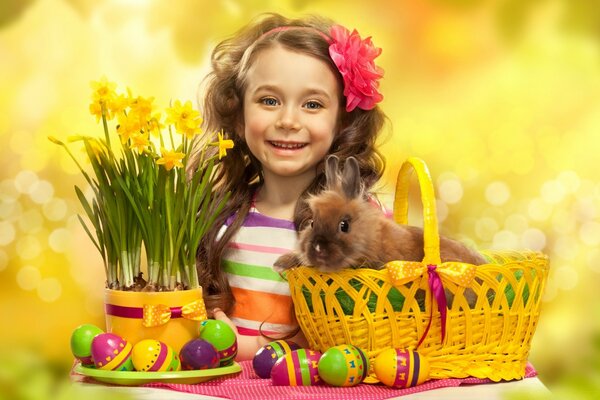 Fille avec lapin et oeufs de Pâques