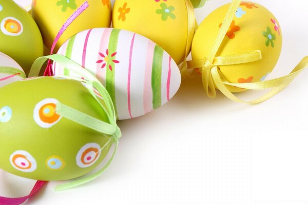 Easter eggs are colored decorated with ribbons