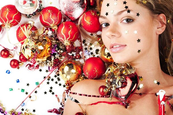 A girl decorated with stars and Christmas tree toys