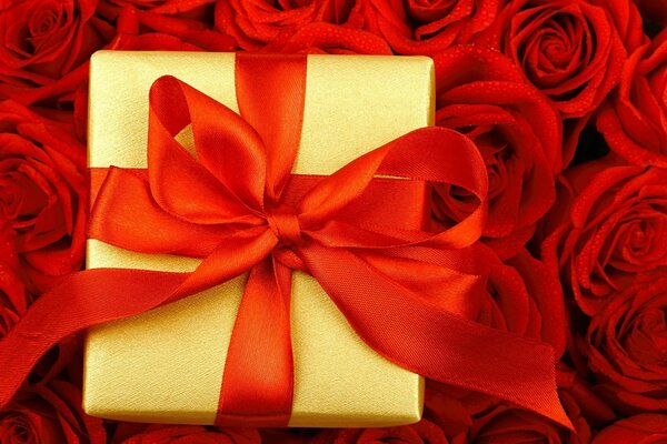 Yellow box with a red bow on red roses