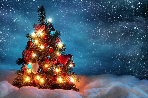 A small Christmas tree with a garland and parsley in the snow