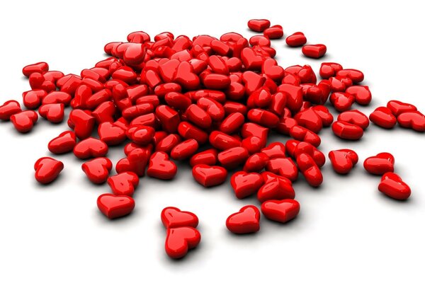 Red heart-shaped tablets on a white background