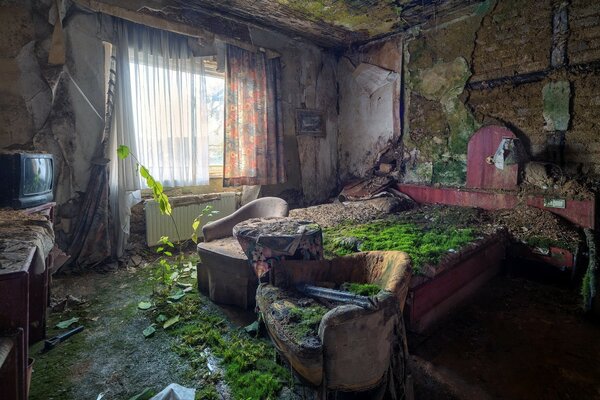 An abandoned house with a large bed