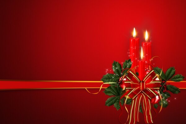 Three red candles decorated with a gift bow and fir branches