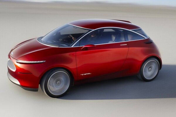 Red concept car on grey sand