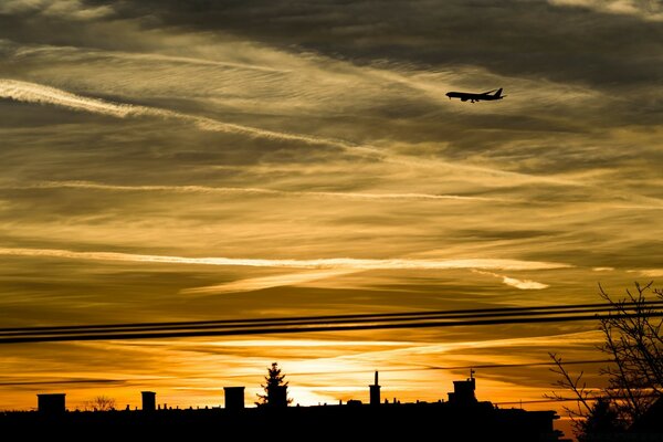 Flugzeug im Hintergrund der Stadt mit Sonnenuntergang