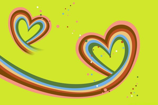 Hearts made of colored ribbons on a green background