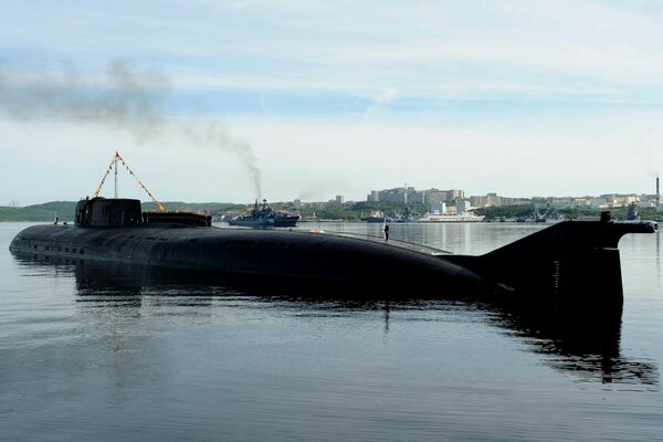 A huge submarine begins diving into the water