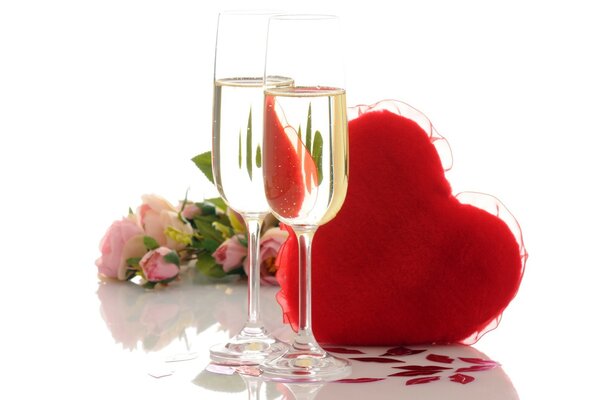 Two glasses of champagne with a heart and a bouquet