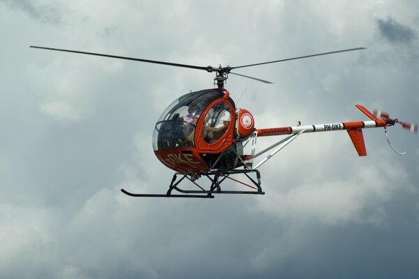 Red helicopter in the sky close-up