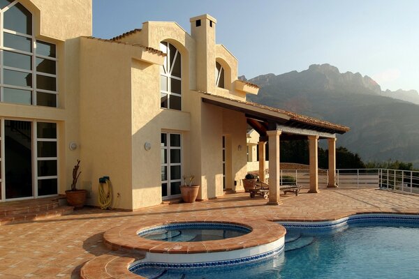 A large cottage with a swimming pool in the mountains