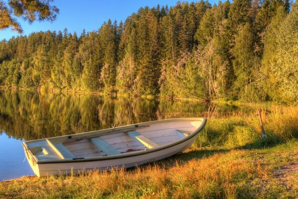 Autumn landscape with a boat by the lake