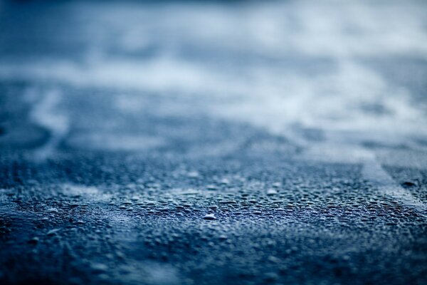 Macro shooting. Textured blue surface. Frozen droplets