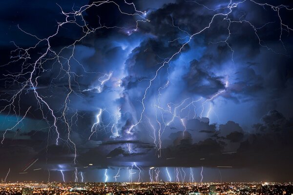 Thunder and lightning over the lights of the night city