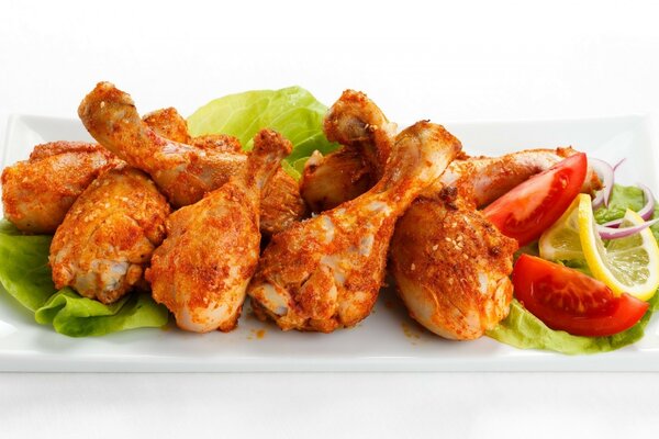 Delicious wings on lettuce leaves. Serving chicken wings