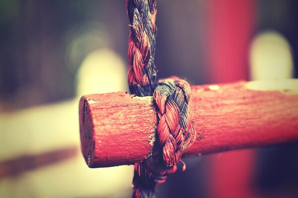 The red wood is tied with a rope