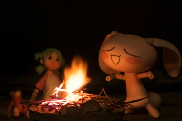 Evening bonfire with two dolls