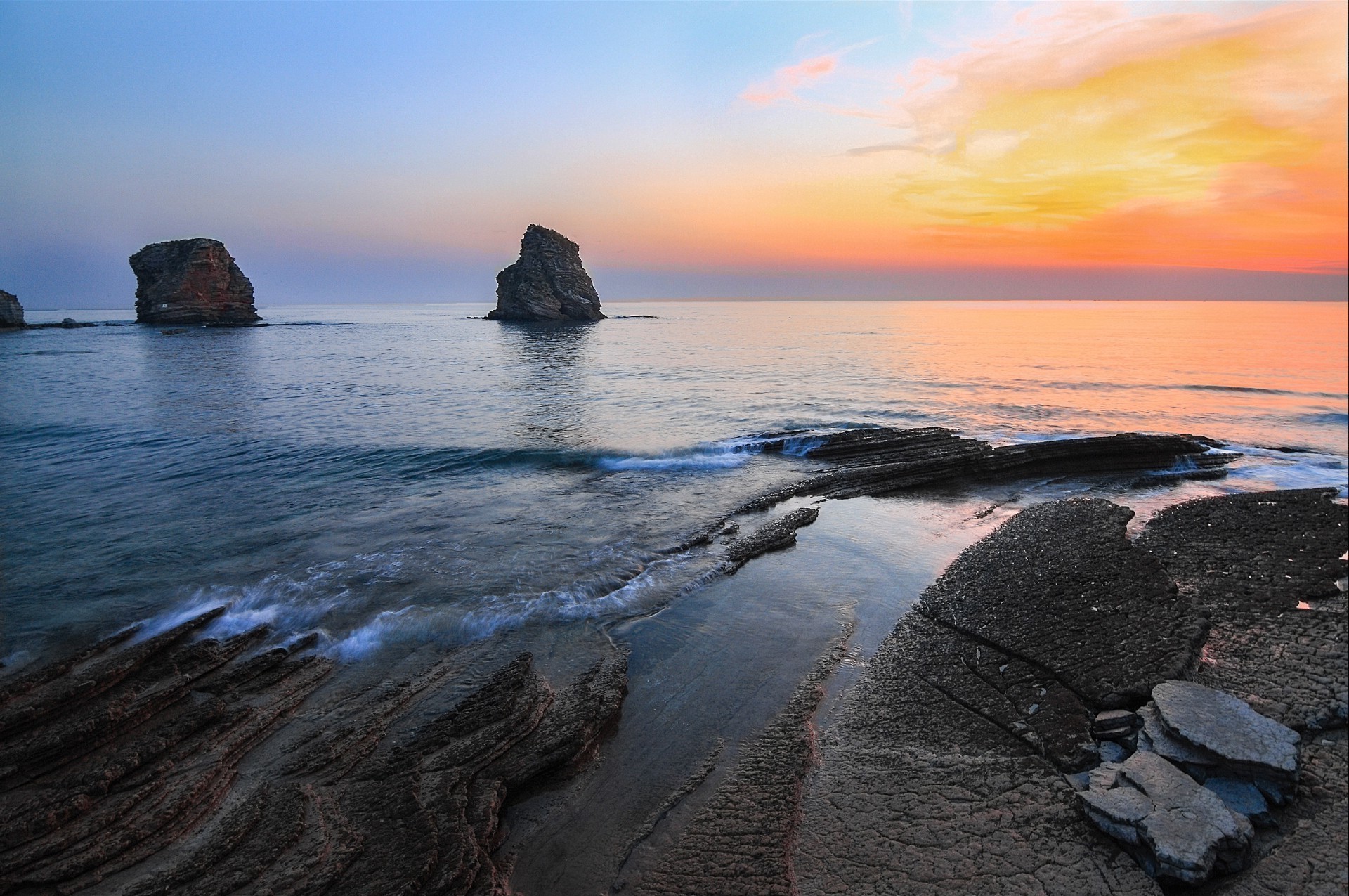 rocks boulders and stones water sunset beach sea seashore ocean seascape landscape travel dawn evening dusk sun surf rock