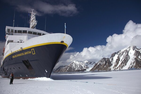 Icebreaker in winter. A man nearby