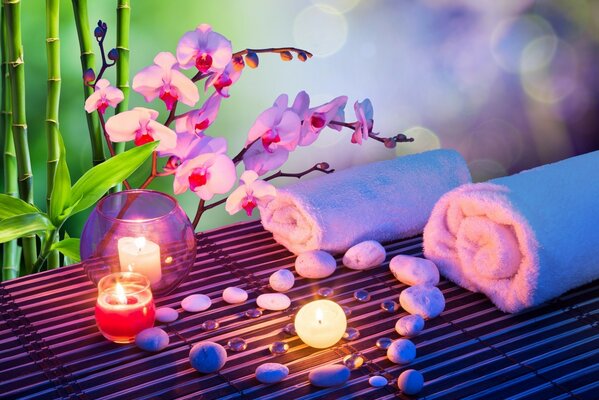 Flowers, stones and towels in the candlelight