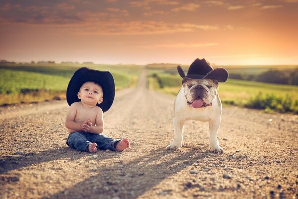 A young cowboy and his faithful dog in hats