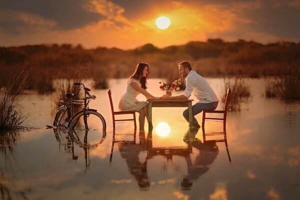 A couple in love at sunset at the table