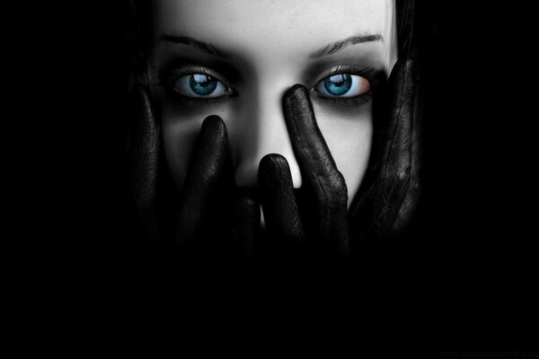 Graphic face of a girl looking through her palms