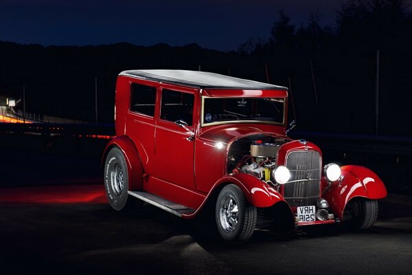 Red retro car on black background