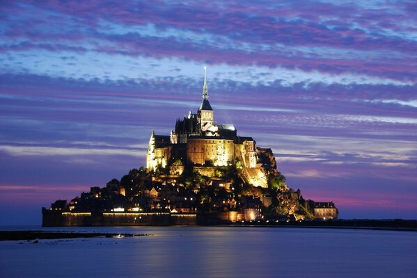 CASTLE AT DAWN AMONG THE WATER SURFACE