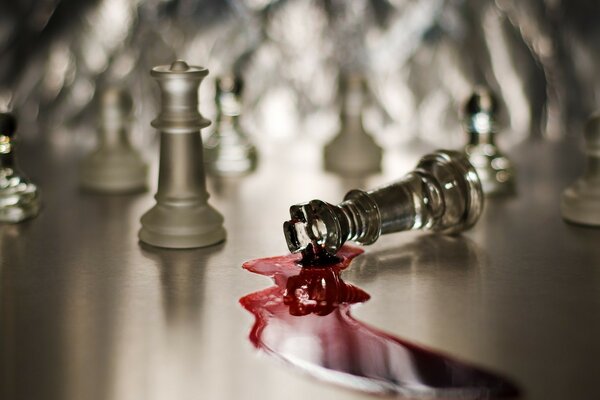 Glass chess pieces blood flows