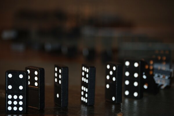 A row of dominoes on a table in macro photography