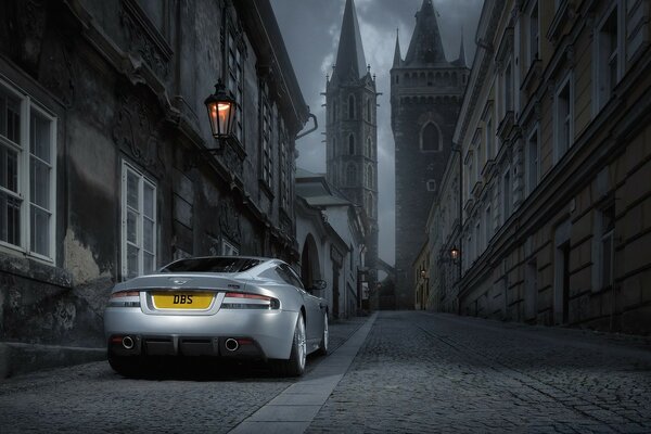 A silver car on the street of a foggy city