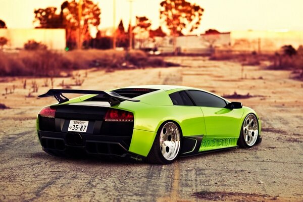 Green sports car outside the city