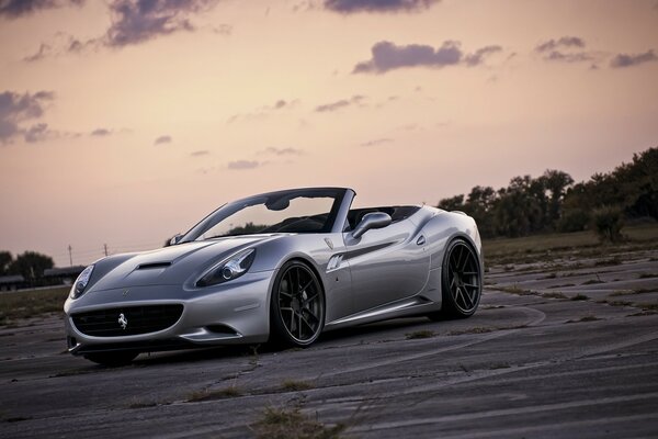 Silver Lamborghini on sunset background