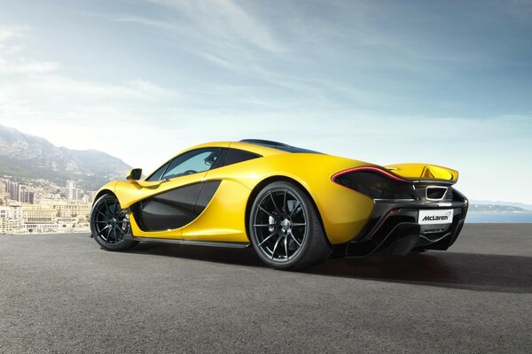 Bright yellow car on the sky background