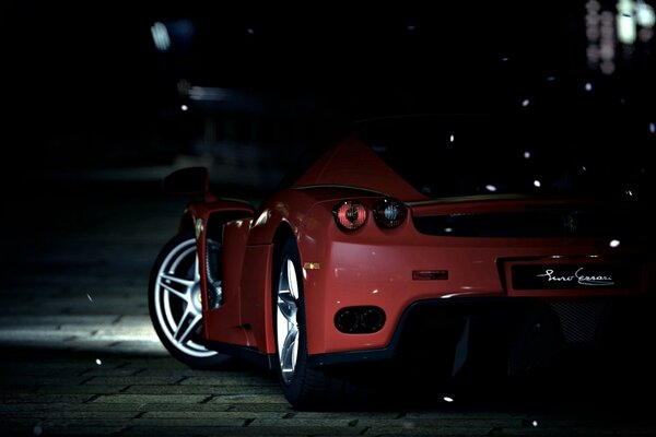 A red Ferrari in a dark alley with white wheels