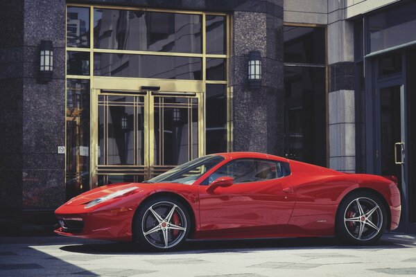 Red double Ferrari spider in front of the hotel